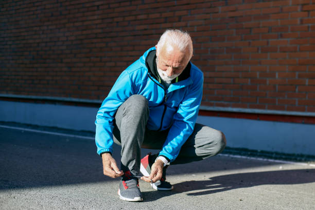 Senior man tying his shoelaces
