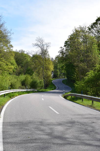 istock very curvy Eifel road up a hill with many esses 1383077127