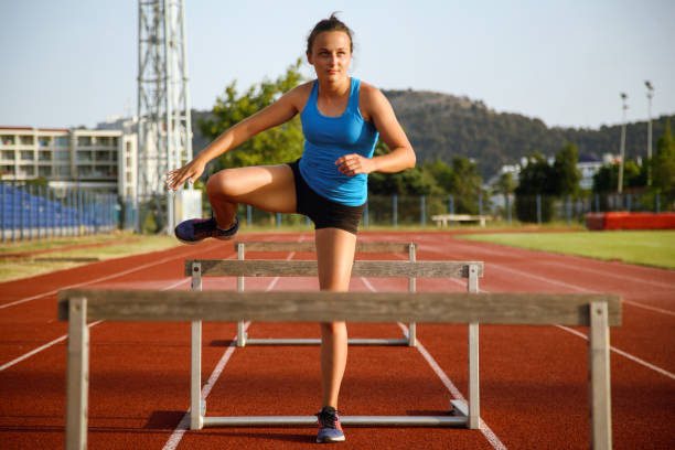 istock Young woman running an obstacle race 1383082277