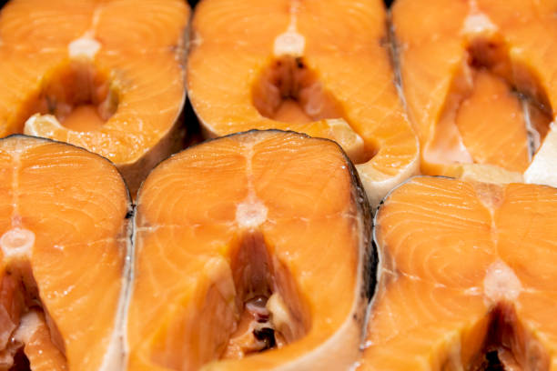 pink salmon steaks shot close-up. red sea fish in butchered form. - pink salmon imagens e fotografias de stock