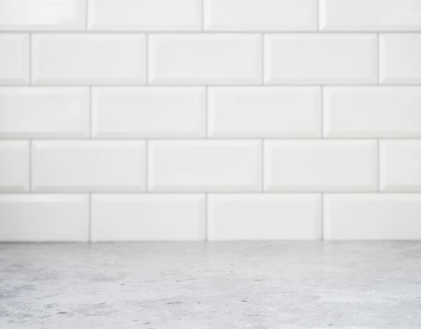 istock Grey marble countertop against a white brick wall. Kitchen interior, free space for text or object. Blurred background 1383084424