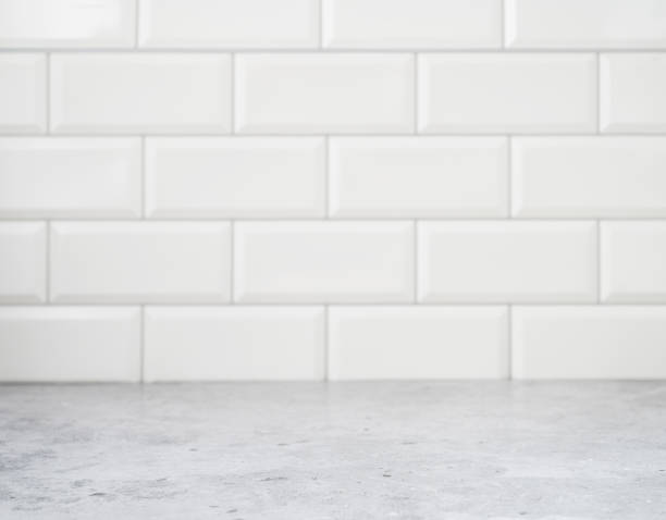 grey marble countertop against a white brick wall. kitchen interior, free space for text or object. blurred background - balcão imagens e fotografias de stock