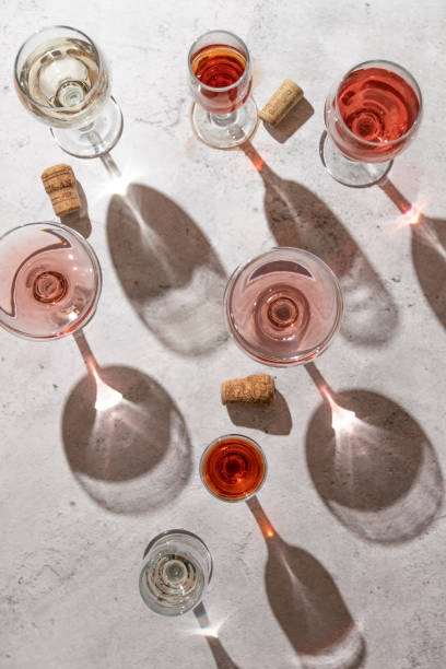 istock Wine glasses on grey background. Direct sunlight, aesthetic still life 1383086172