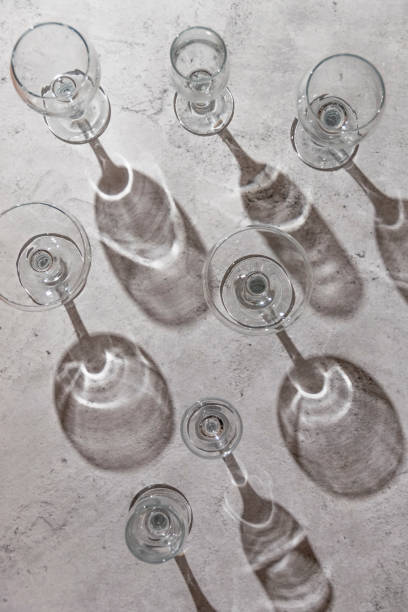 istock Empty wine glasses on grey background. Direct sunlight, aesthetic still life 1383086173