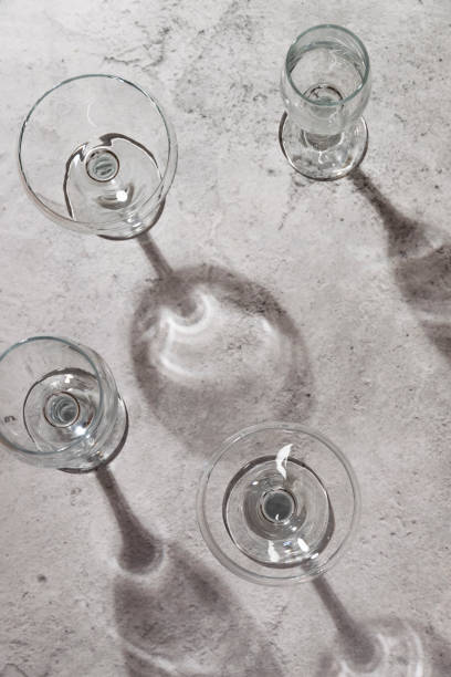 istock Empty wine glasses on grey background. Direct sunlight, aesthetic still life 1383086174