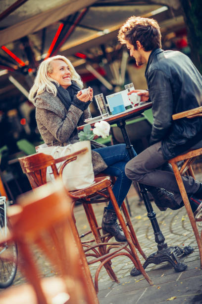 istock Happy young couple enjoying coffee at bar 1383086984