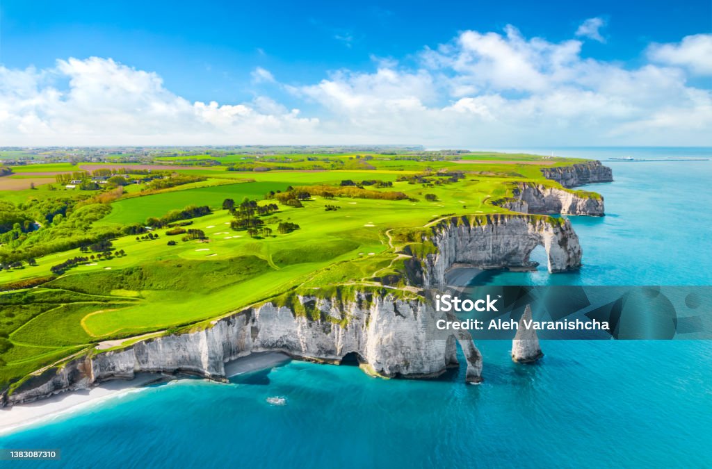 Picturesque panoramic landscape on the cliffs of Etretat. Natural amazing cliffs. Etretat, Normandy, France, La Manche or English Channel. Coast of the Pays de Caux area in sunny summer day. France Picturesque panoramic landscape on the cliffs of Etretat. Natural amazing cliffs. Etretat, Normandy, France, La Manche or English Channel. France France Stock Photo