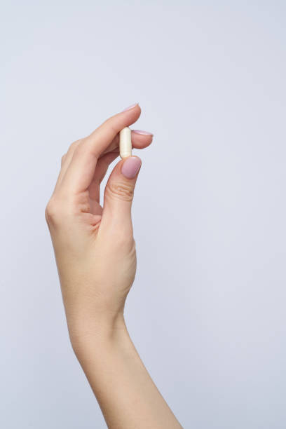 istock woman hand hold drag or medicine on white background 1383088904
