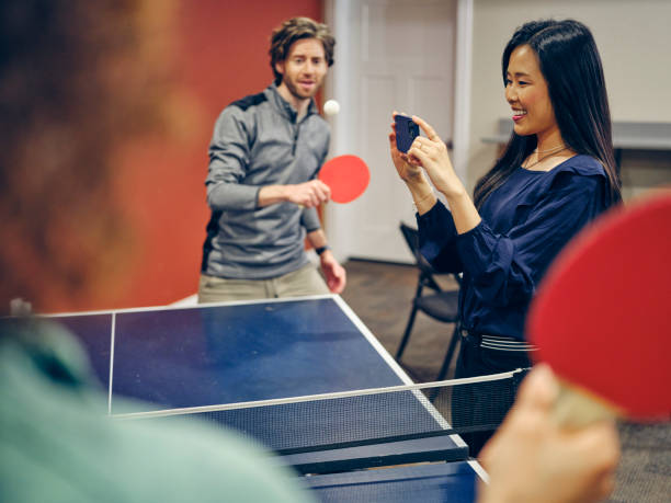istock Office Workers Playing Ping Pong in the Break Room 1383091853