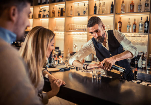 istock Young couple sitting at cafe counter 1383093009