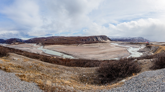 Autumn greenlandic wastelands landscape with river and mountains in the background, Kangerlussuaq, Greenland