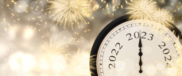 istock New Year 2023 clock and fireworks background. 1383098670