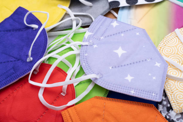 istock Heap of  different various colors face masks respirators. Top view flat layer. Protection from covid virus during pandemic. 1383099115