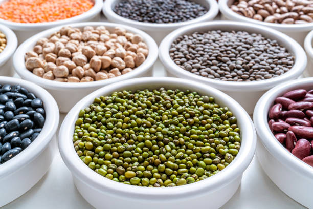 green soybeans mung beans dried legumes assorted in many bowls on white - lentil full frame macro close up imagens e fotografias de stock