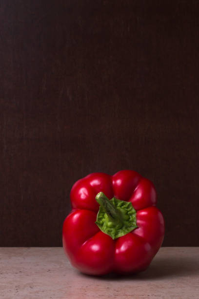 istock Red bell pepper on a rustic dark brown background 1383104619