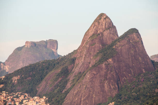 Two hill brother and gavea stone seen from ipanema beach in rio de janeiro. Two hill brother and gavea stone seen from ipanema beach in rio de janeiro, Brazil. two brothers mountain stock pictures, royalty-free photos & images