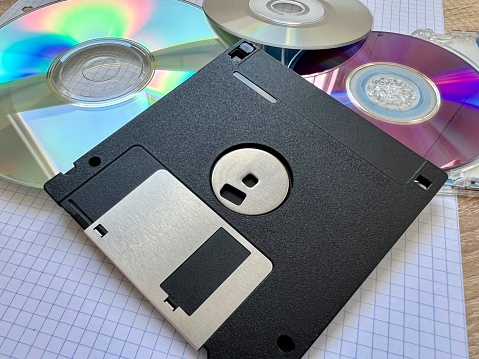 old floppy disk and cd background with blank space