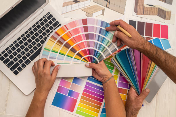 istock two colleagues interior designers discussing about color for renovation on house plan 1383108211