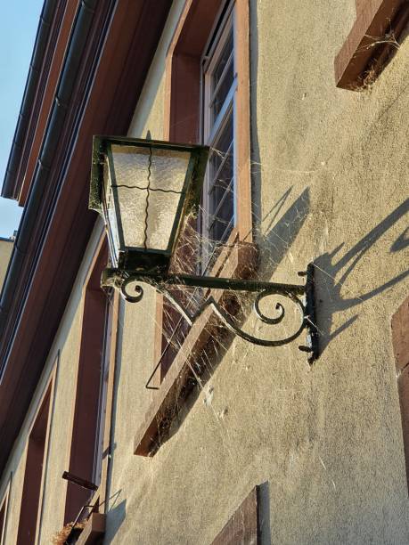 istock Streetlamp in front of a building 1383108843
