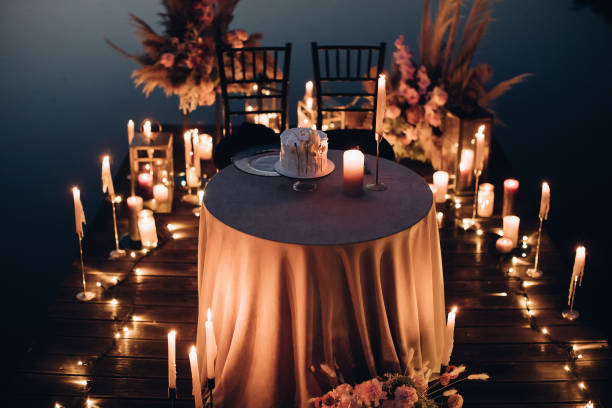 istock Romantic dinner for two by candlelight on the beach in the evening 1383108966
