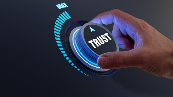 Trust in business and finance relationships. Trusted partner, contract, agreement or assurance concept. Confidence to work together, trustworthy company. Person turning knob to max value.
