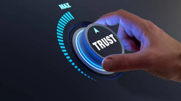 Photo of Trust in business and finance relationships. Trusted partner, contract, agreement or assurance concept. Confidence to work together, trustworthy company. Person turning knob to max value.