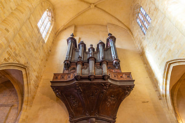 Old organ in a beautiful french yellow stone medieval church of Perigord An old organ in a beautiful french yellow stone medieval church in Sarlat-la-Caneda, Perigord, France, taken on a sunny autumn afternoon sarlat la caneda stock pictures, royalty-free photos & images