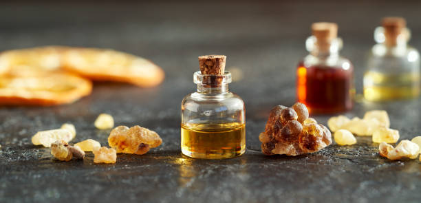 a bottle of frankincense essential oil with frankincense resin crystals - tree resin imagens e fotografias de stock