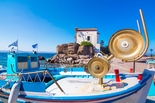 She looks at the beautiful traditional greek town on the hill on Ios Island, Greece.