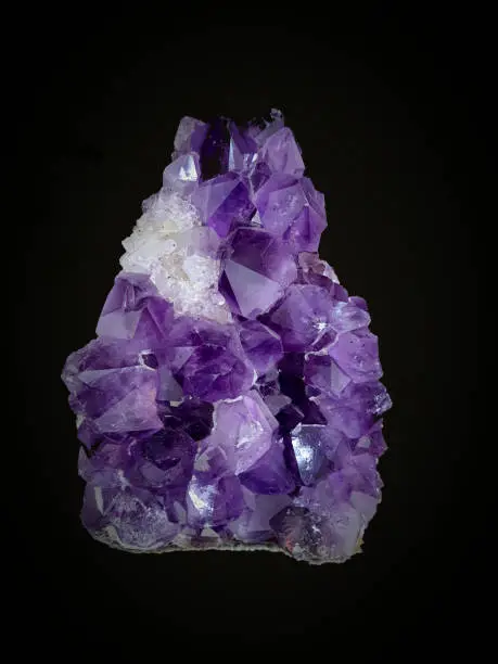 Amethyst stone. Precious violet variety of quartz. On a black background.
