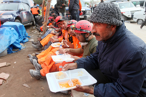 Van, Turkey - October 25: Earthquake victim man and rescue team eating lunch on October 25, 2011 in Van, Turkey. It is 604 killed and 4152 injured in Van-Ercis Earthquake.