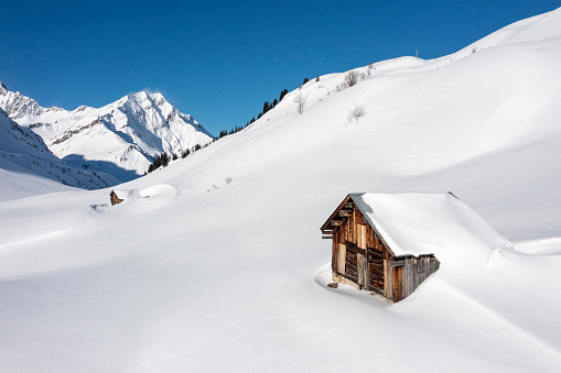Aerial view of an old hut in the mountains during winter. Hochtannberg, Vorarlberg