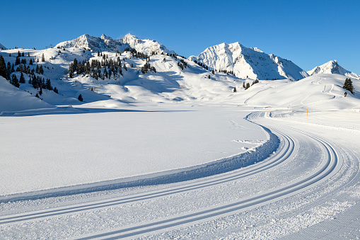 Winter landscape with cross-country ski trail in the mountains. Hochtannberg, Vorarlberg