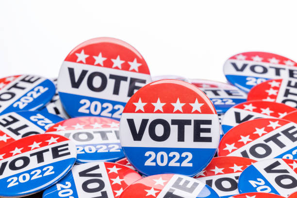 Get Out the Vote High quality stock photos of vote campaign buttons with room for copy and with an American Flag. voting stock pictures, royalty-free photos & images