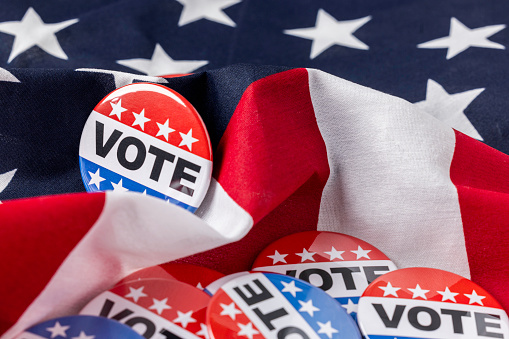 High quality stock photos of vote campaign buttons with room for copy and with an American Flag.