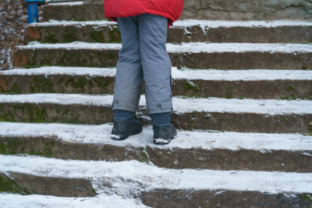 istock Child standing n the staircase in winter day. 1383122804