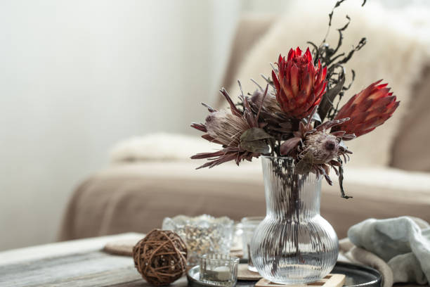 istock Cozy home composition with candles and protea bouquet. 1383123723