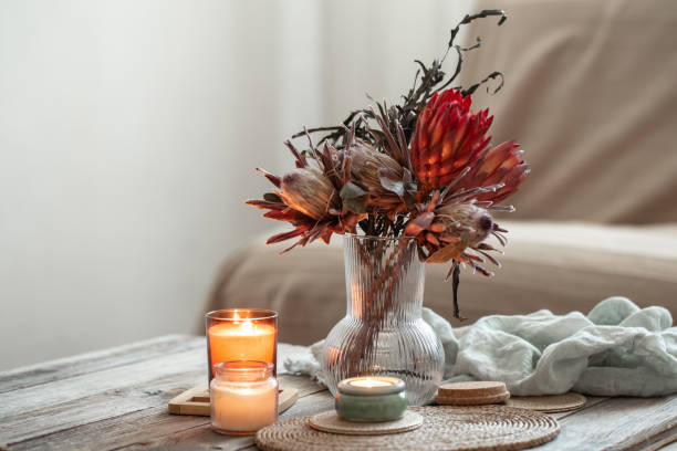 istock Cozy home composition with candles and protea bouquet. 1383123724