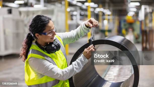 Hispanic Woman In Plastics Factory Inspecting Product Stock Photo - Download Image Now