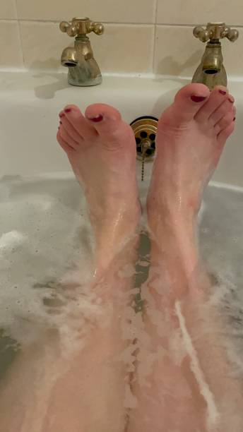 istock Women’s feet in bath 1383129690