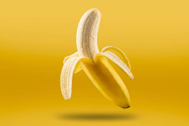 istock Ripe bananas isolated on yellow background. 1383134648