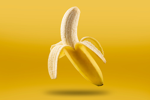 Ripe bananas isolated on yellow background.