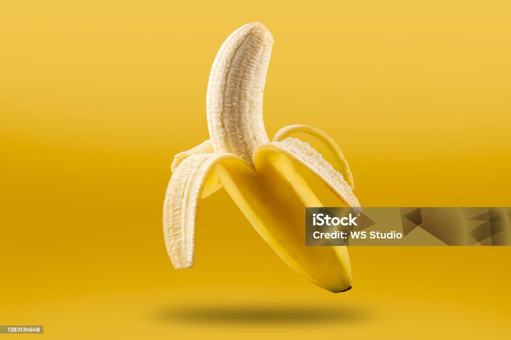 Ripe bananas isolated on yellow background. Banana Stock Photo