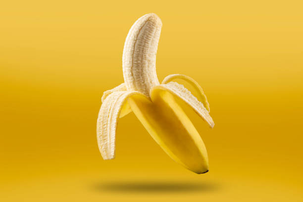 Ripe bananas isolated on yellow background. Ripe bananas isolated on yellow background. banana stock pictures, royalty-free photos & images