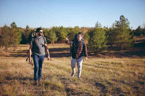 istock Backpackers going hiking and walking through a sandstone valley 1383136254
