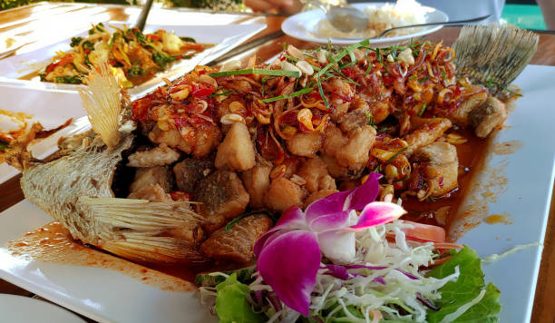 istock Fried snapper fish in spicy herb salad 1383137065