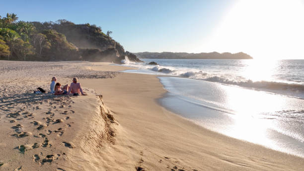 They chat and look off towards Pacific Ocean in the distance