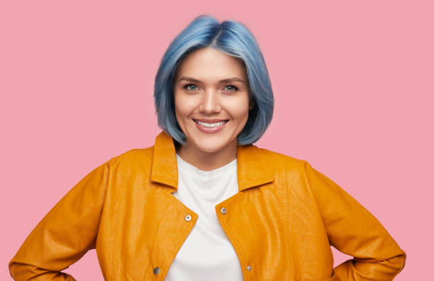 istock Stylish young lady smiling at camera against pink background 1383176450
