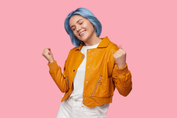 istock Delighted young woman celebrating success 1383176469