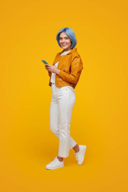 istock Trendy millennial woman with smartphone 1383176490
